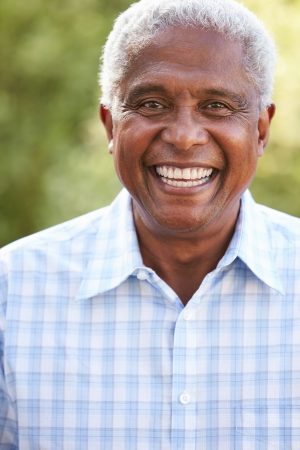 Portrait of smiling senior African American man, vertical